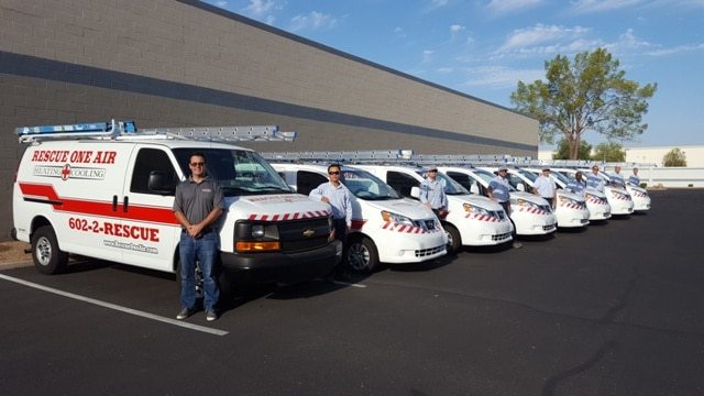 Rescue One Air team members in front of a line of their service vans