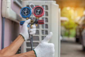 Close up of Air Conditioning technician performing a maintenance check on an AC unit